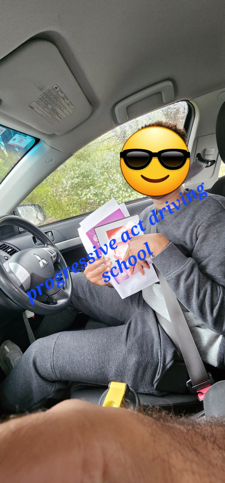 Learner driver with ACT logbook papers after a lesson in Canberra