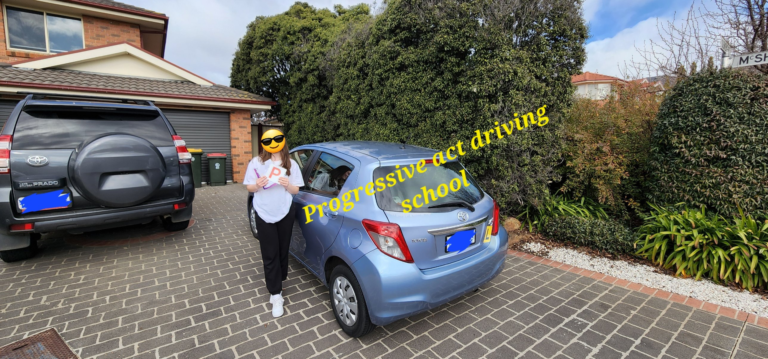 Student with P plates after driving lessons in Canberra